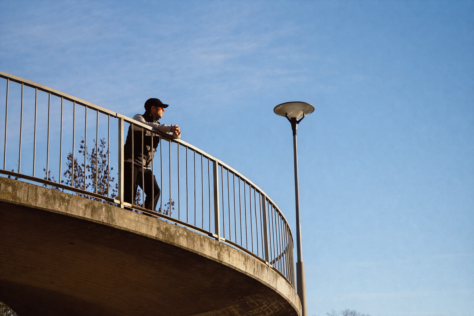 man standing on bridge